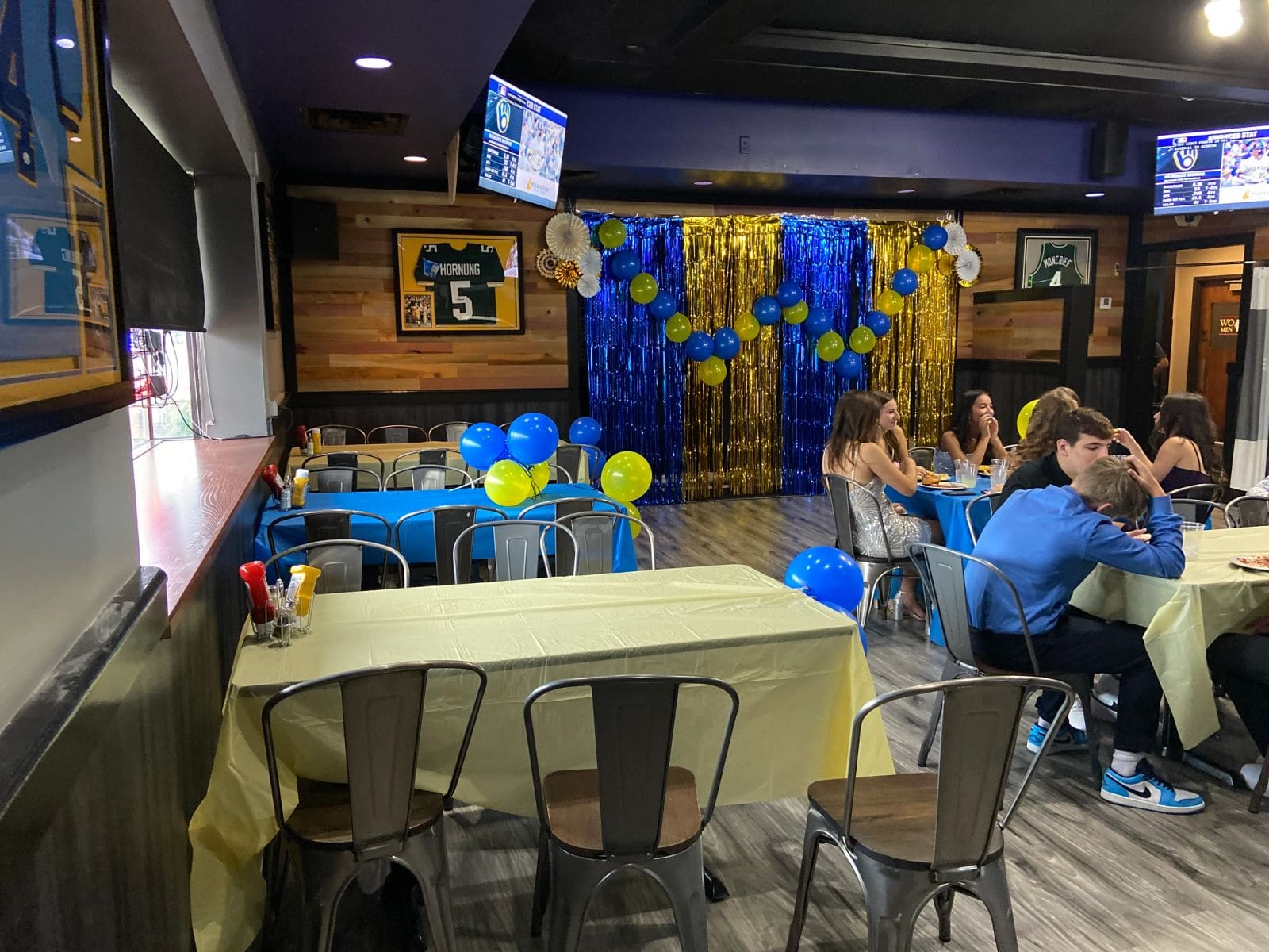 The private party room set with a blue and gold balloon backdrop