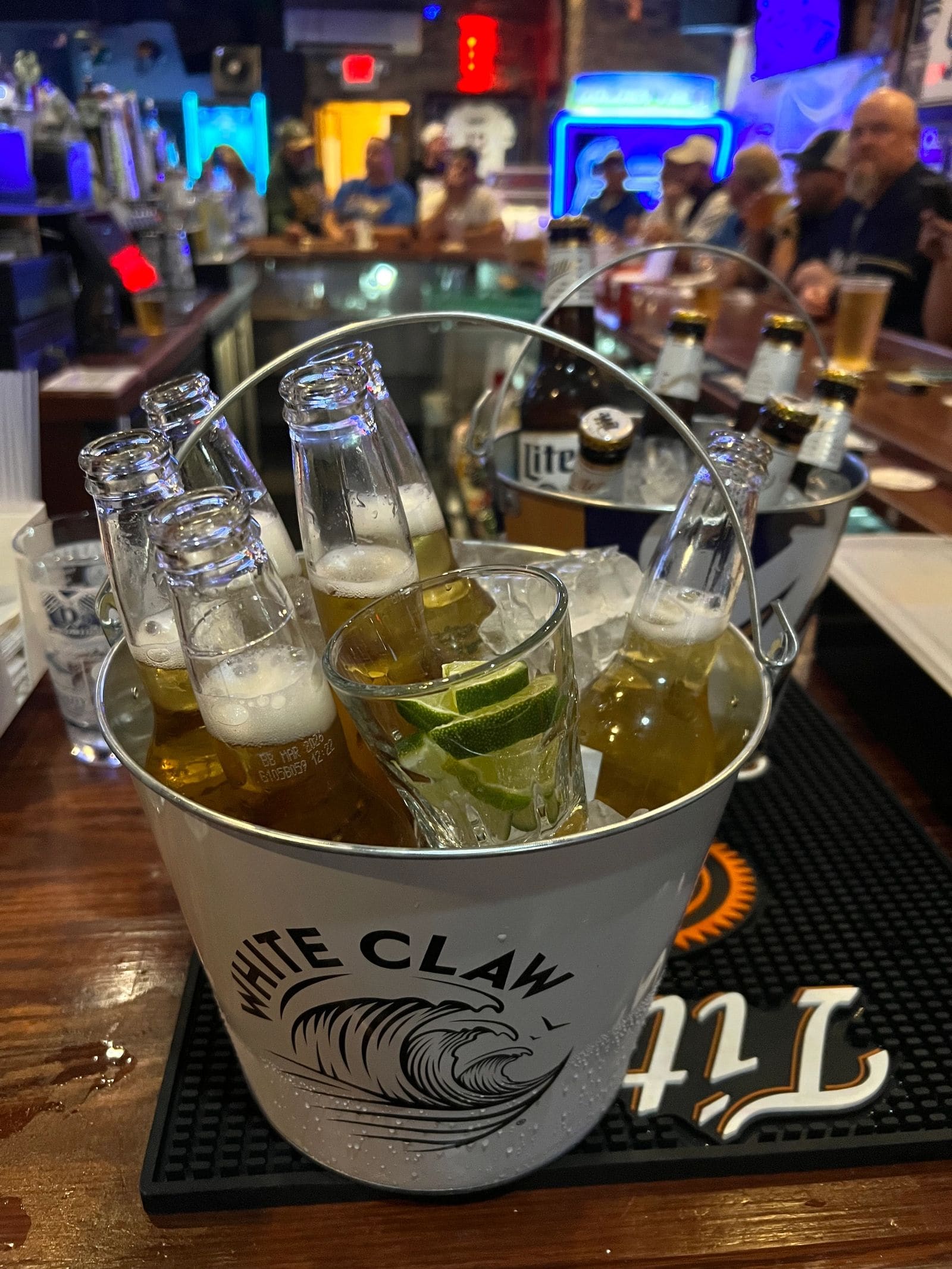 An ice-cold bucket of bottles and seltzers at the bar