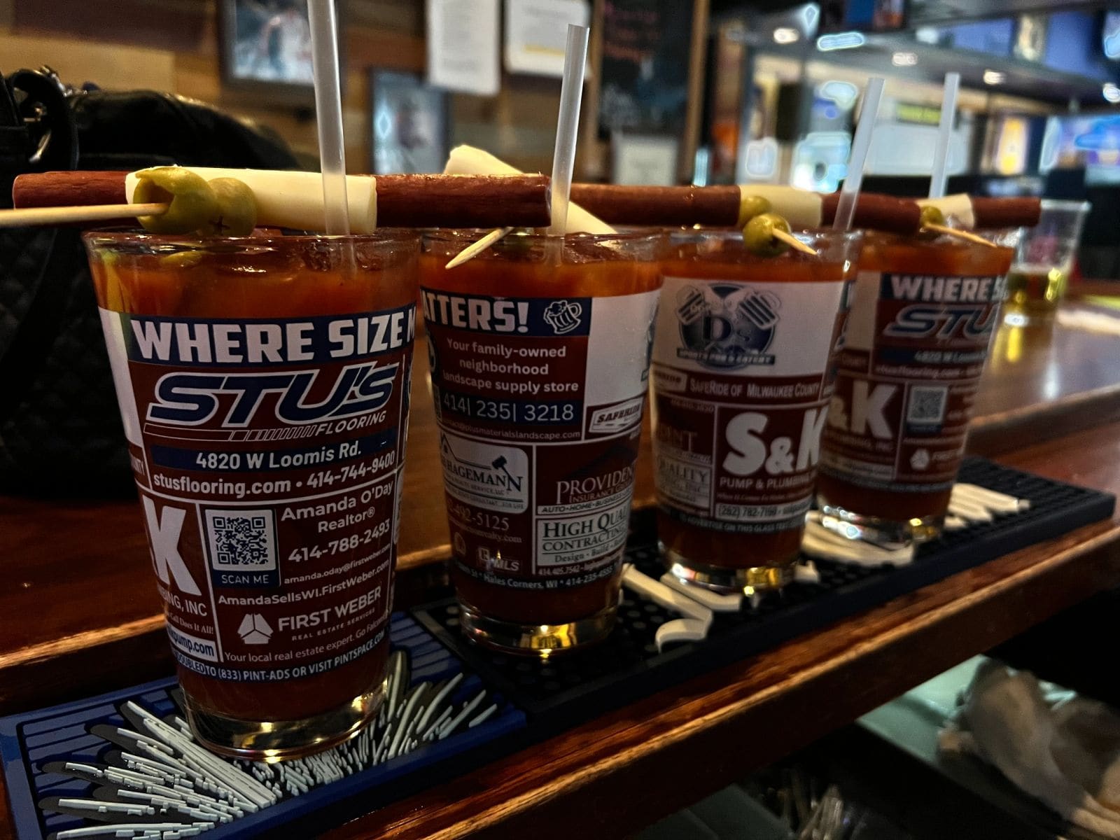 A lineup of loaded Bloody Marys on the bar