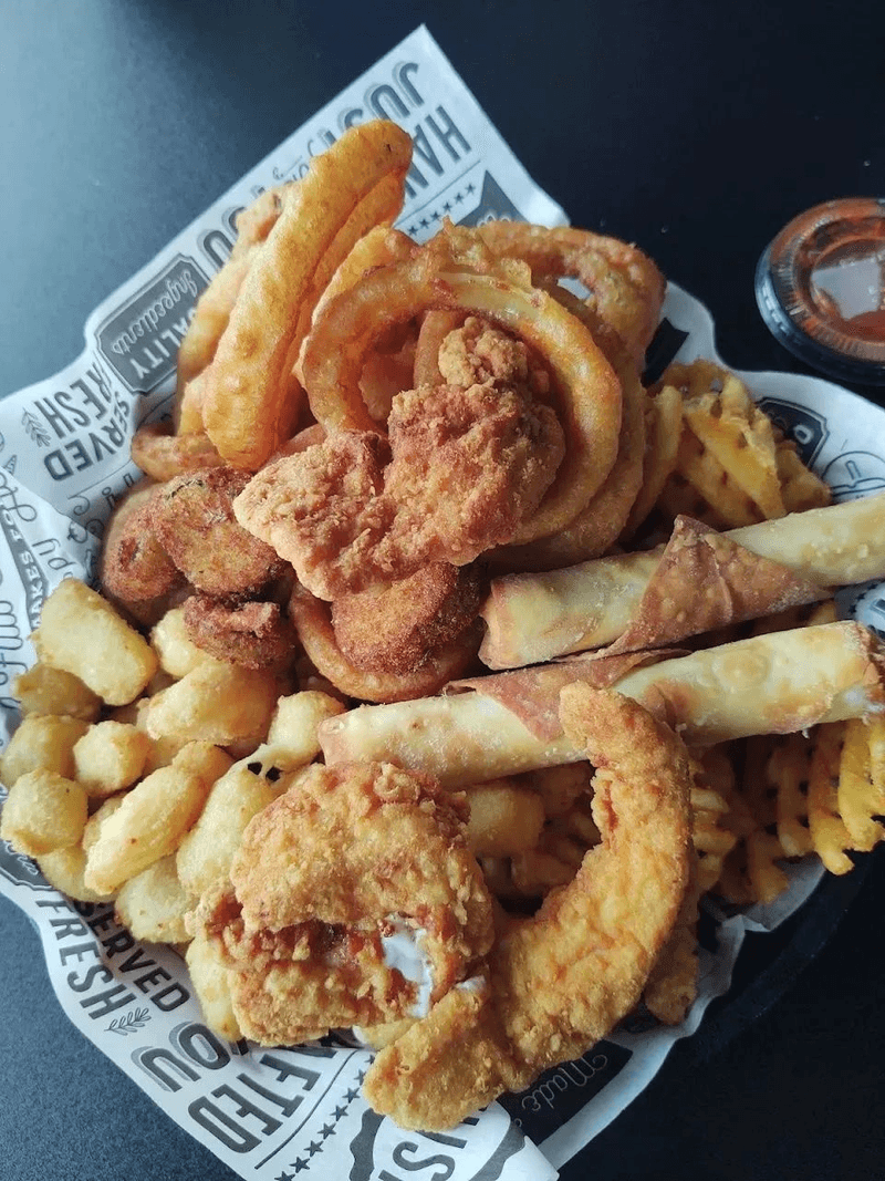 Loaded appetizer combo platter with wings, onion rings and fried favorites