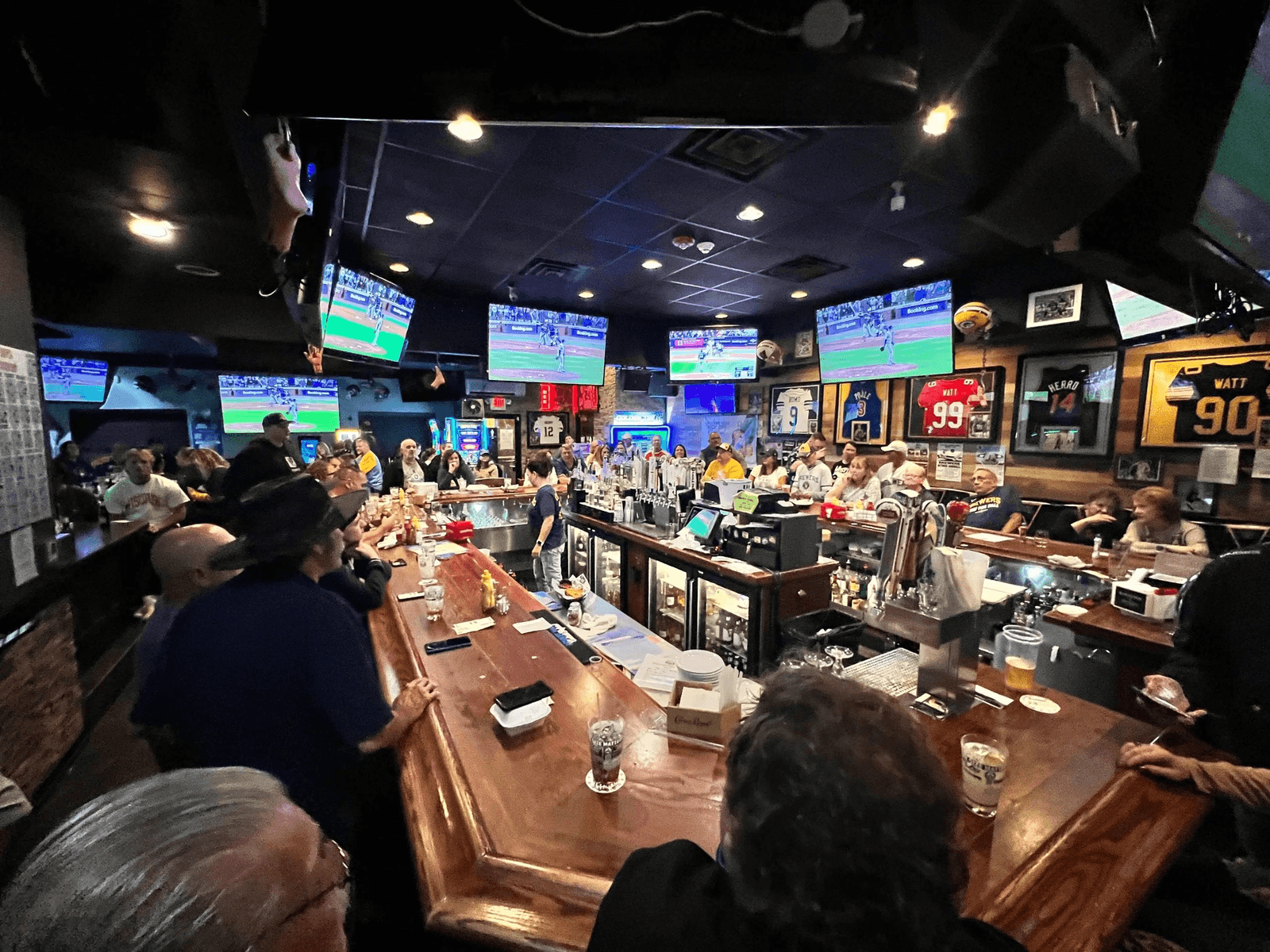 The main bar at Double D's under a wall of TVs on game day